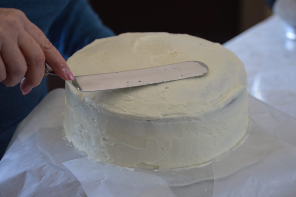 frosting the entirety of the cake