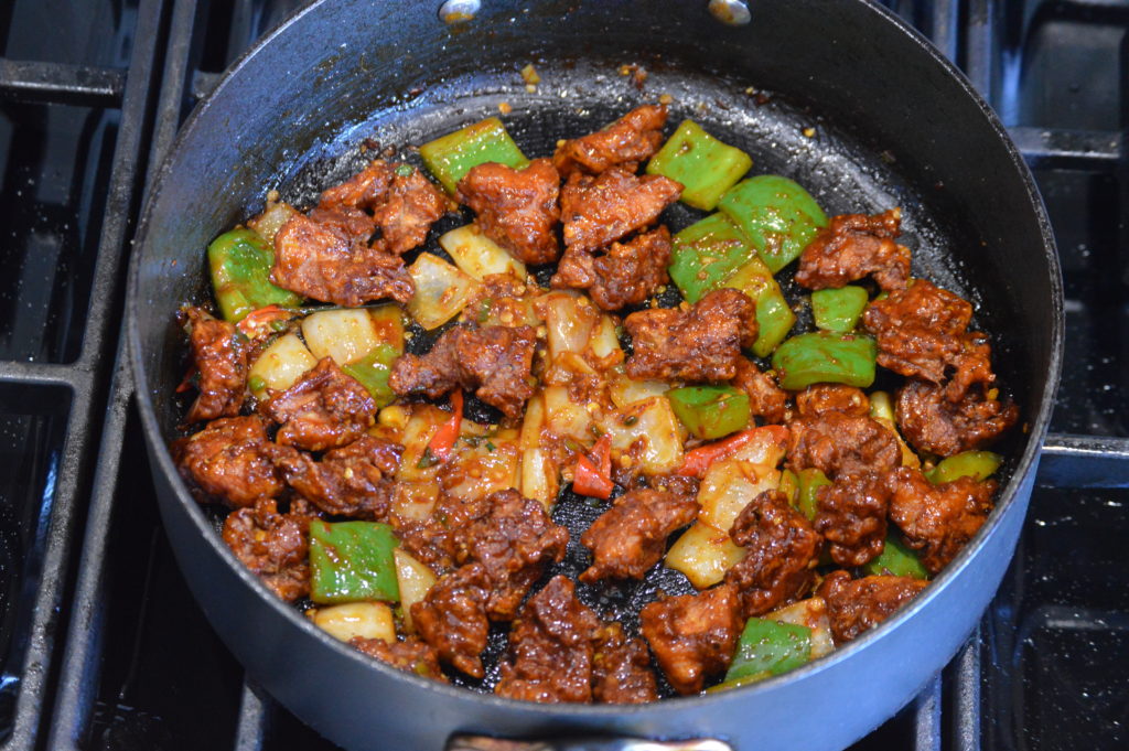 the chicken and sauce is added to make the chilli chicken