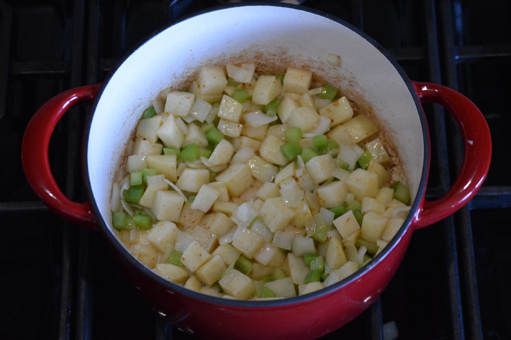 sautéing the vegetables in a pot
