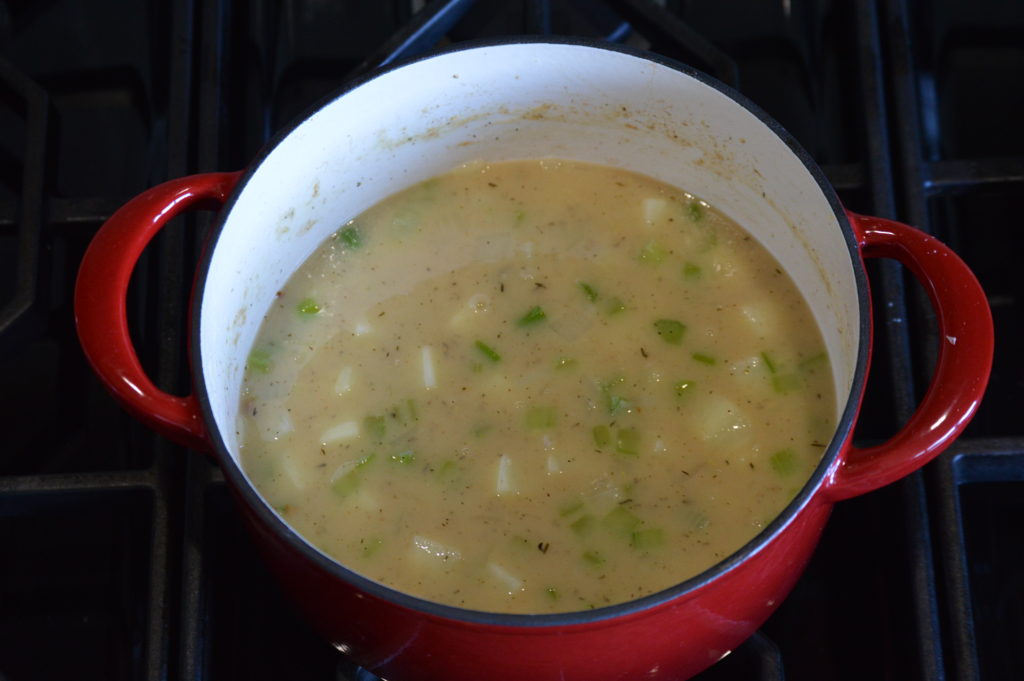 the chicken stock and clam juice is added to the pot