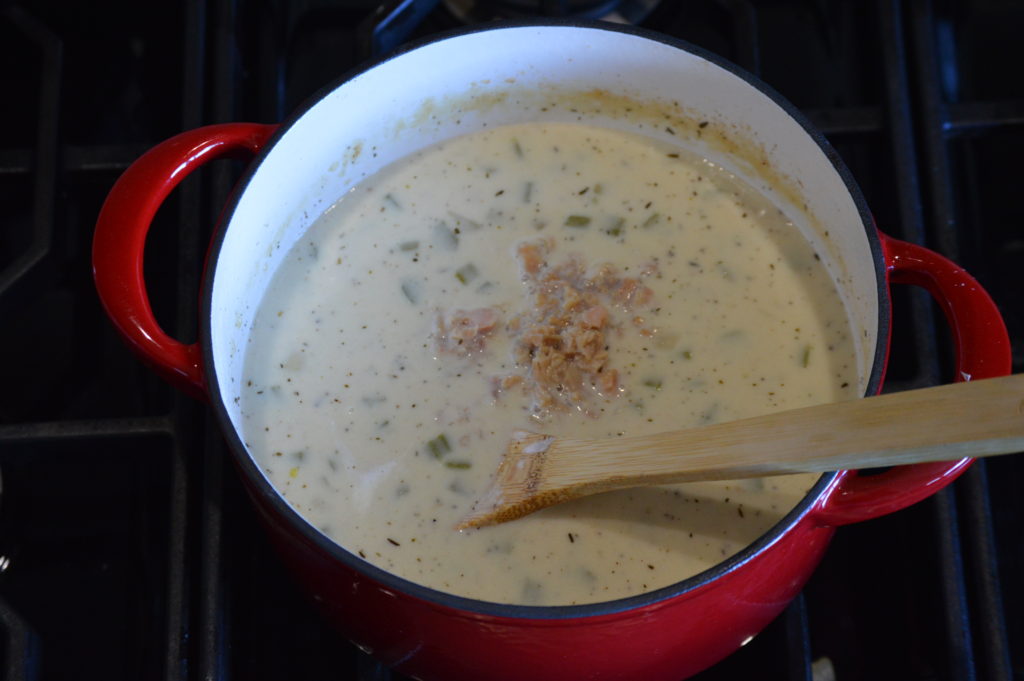 the cream and clams are added to the clam chowder