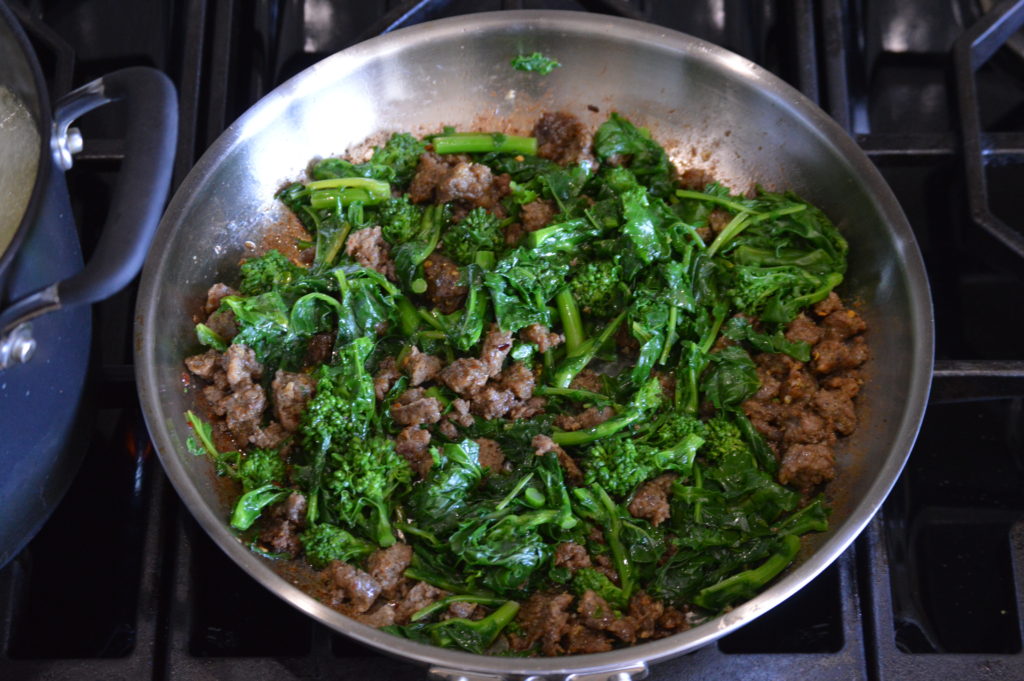 the broccoli rabe is added to the sausage