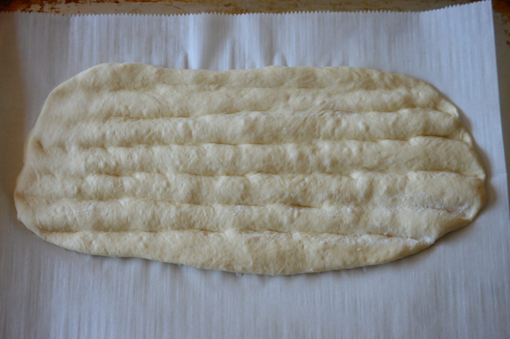 the dough is shaped and the ridges are made by hand