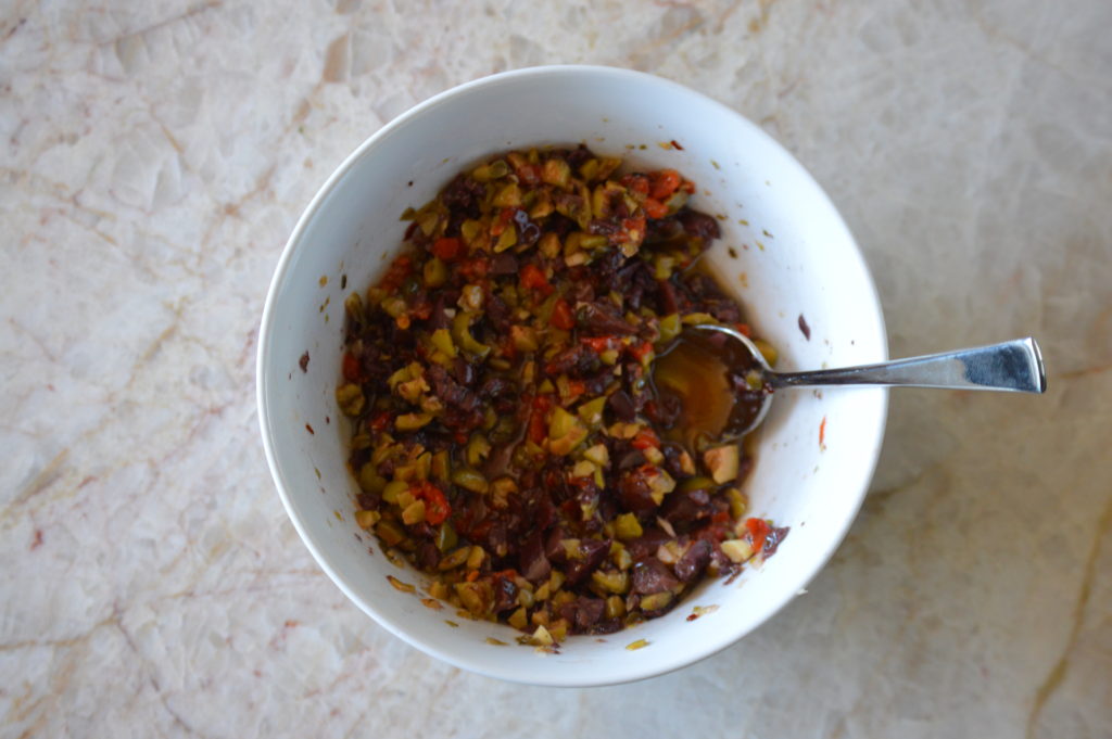 all of the ingredients for the olive tapenade are mixed together in a bowl