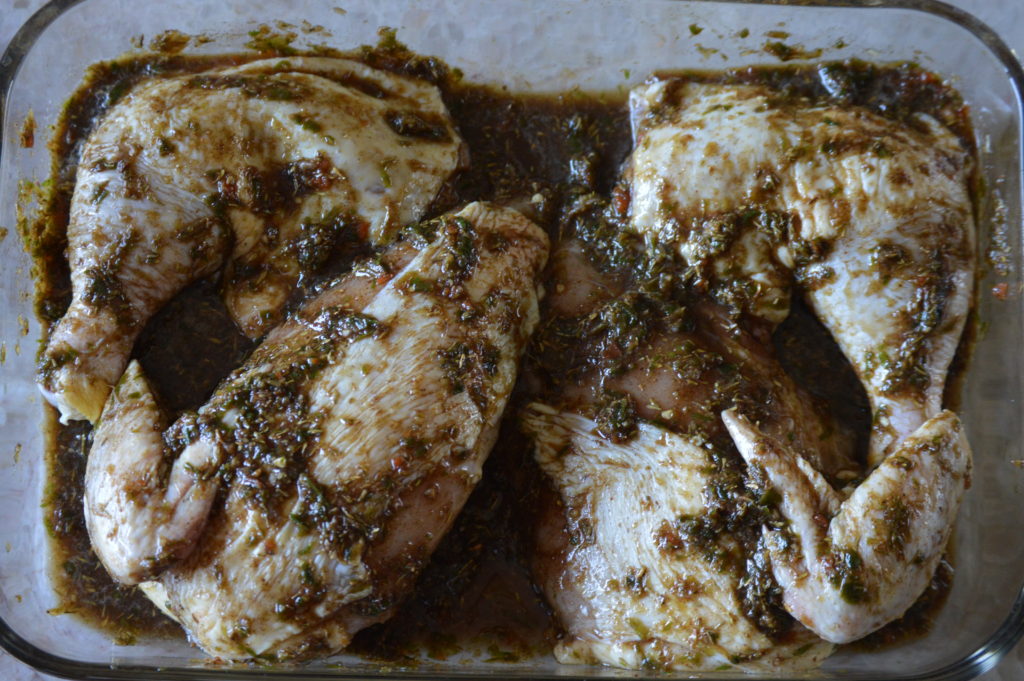 the chicken being marinated in the jerk sauce