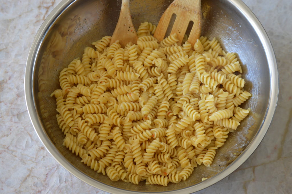 the pasta is tossed with the dressing