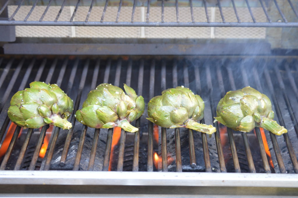 charring up the artichokes on the grill