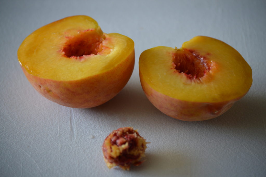 peaches cut in half and the pit is removed