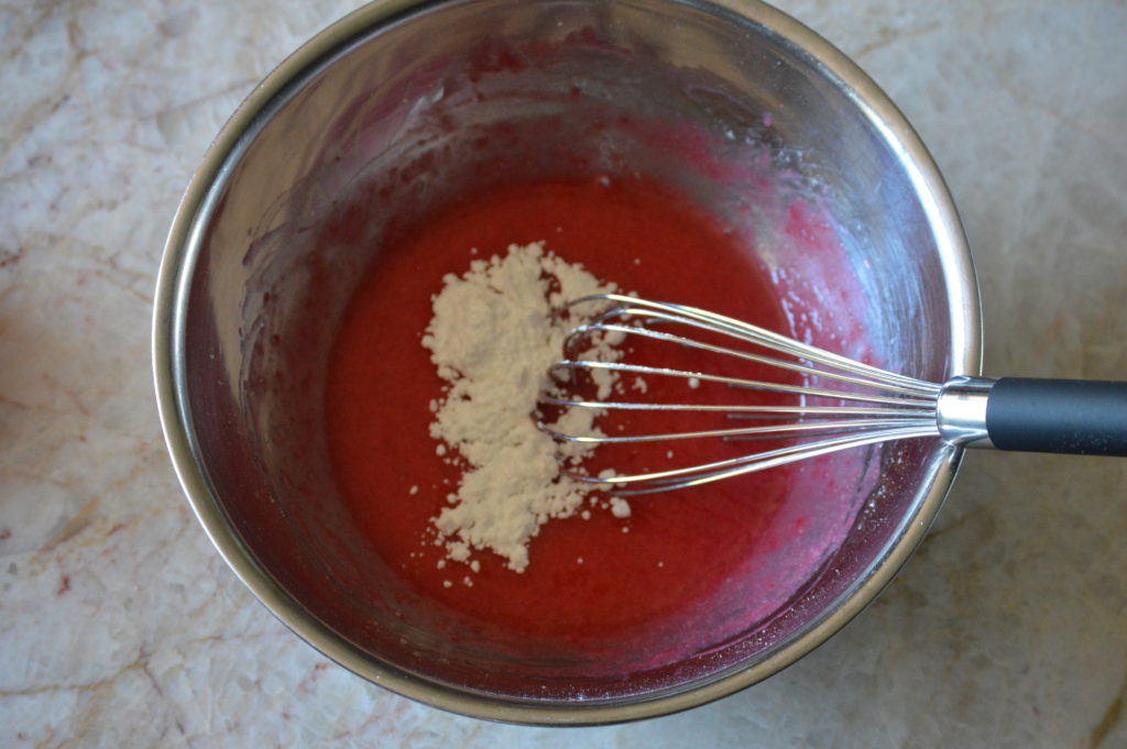 powdered sugar is added to the raspberry puree