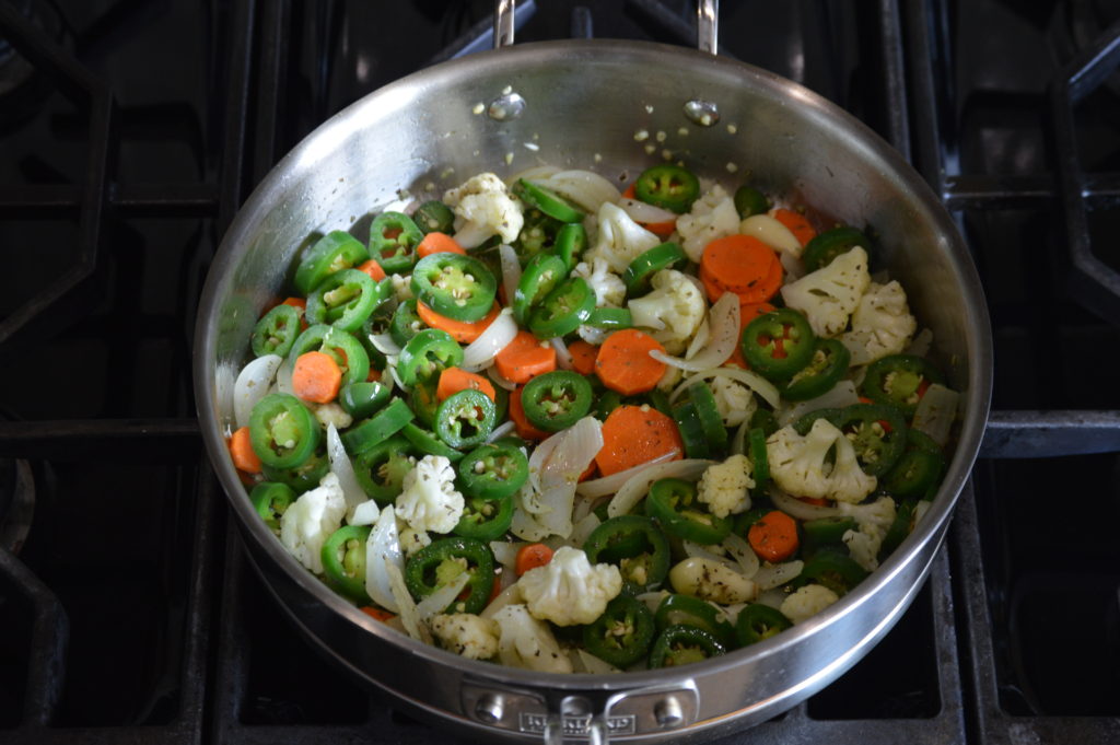 sauteeing all of the vegetables for the jalapenos en escabeche