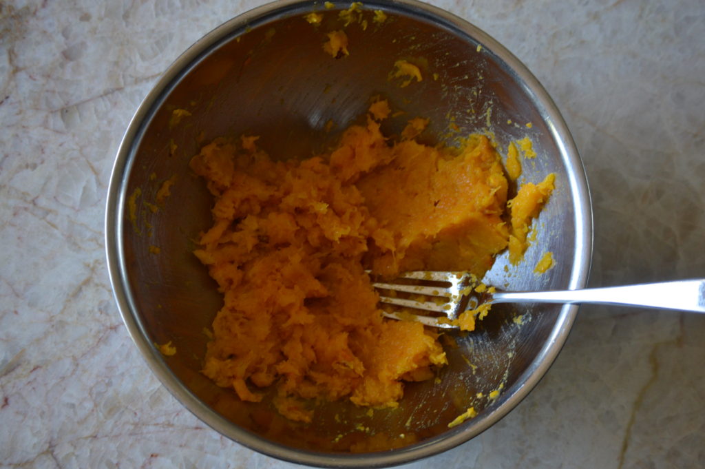 half of the squash is mashed