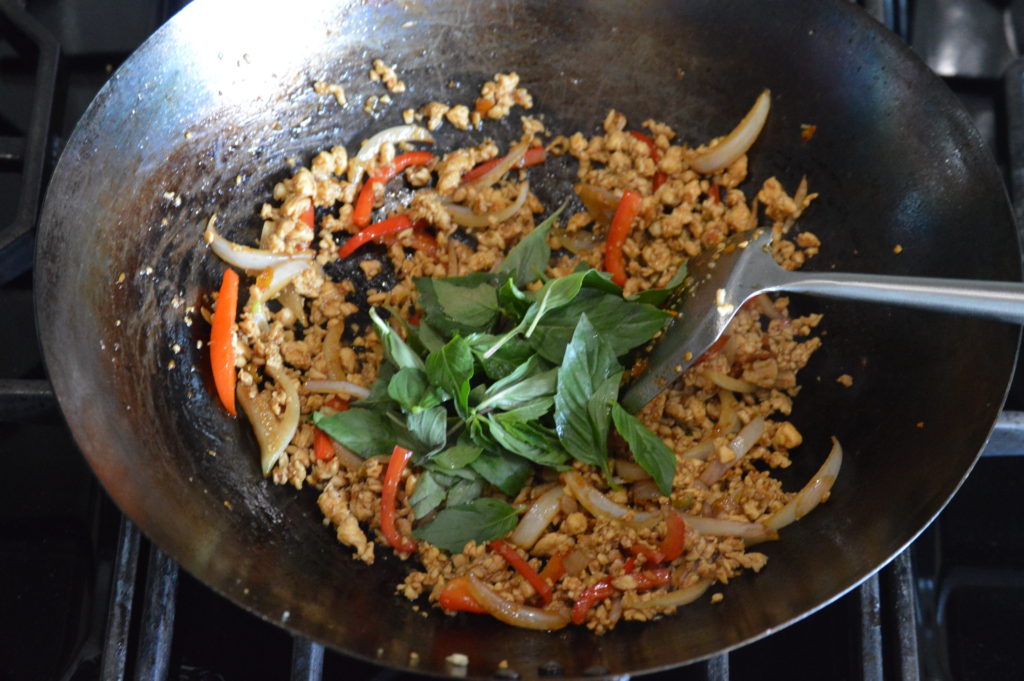 the thai basil is added to the wok