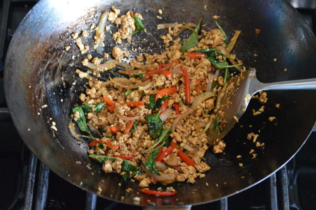 the basil leaves have wilted and the Thai basil chicken is completed