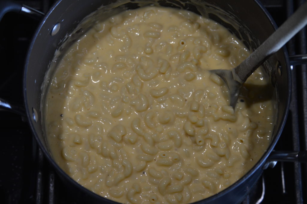 the macaroni is combined with the cheese sauce