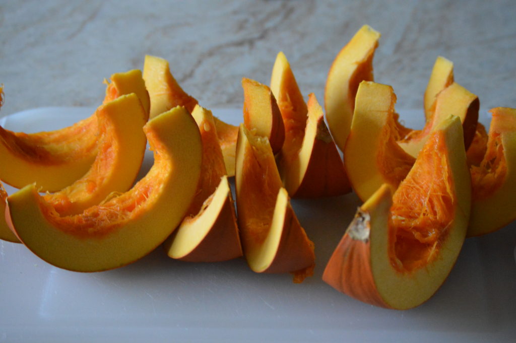the pumpkin is cut into crescent shaped slices