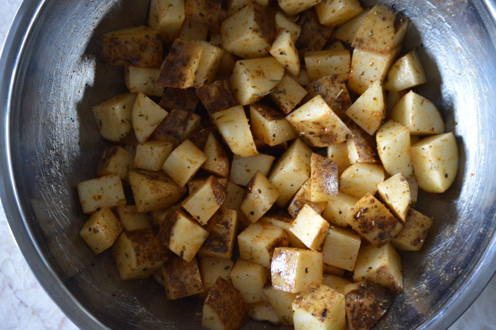 the potatoes are coated in oil and spices