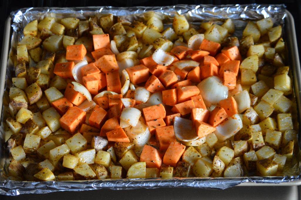 the sweet potato and onion is added to the baking sheet