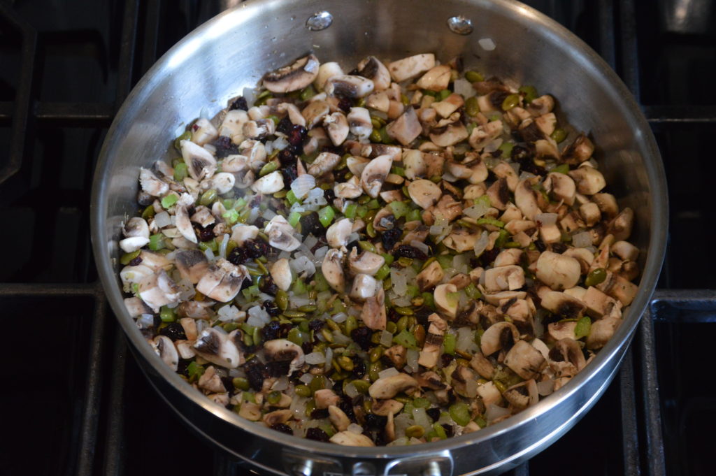 all of the ingredients for the stuffing are cooking in a pan