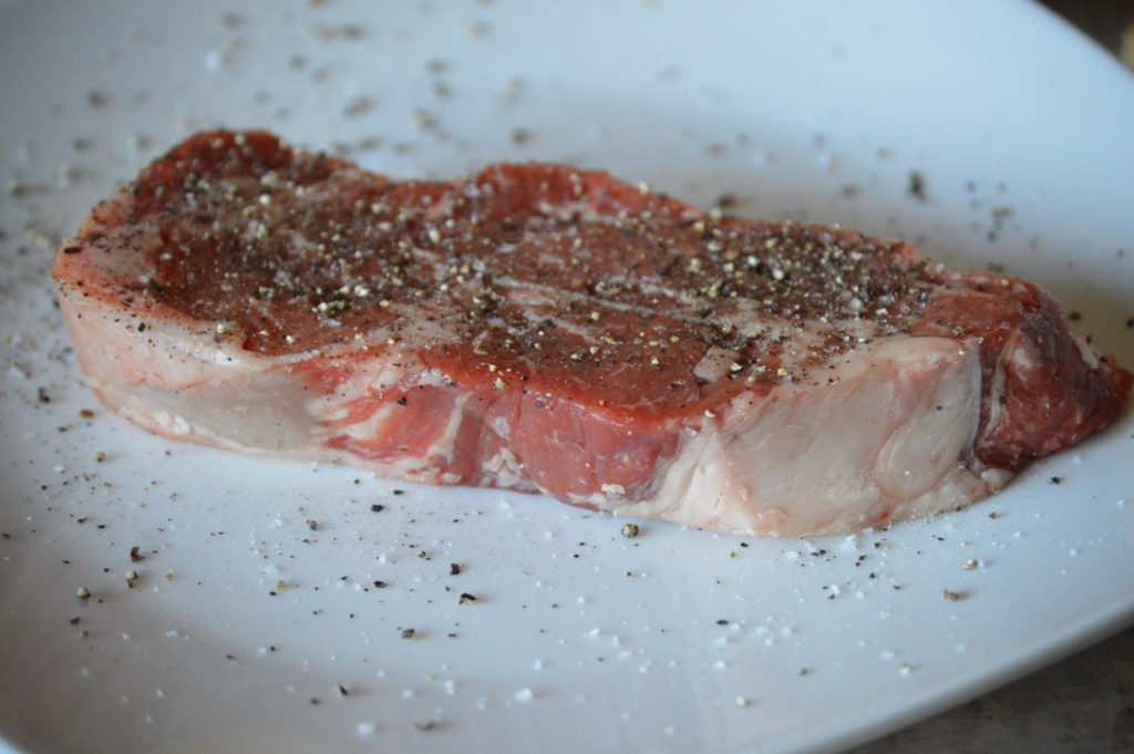 the steak is coated in salt & pepper