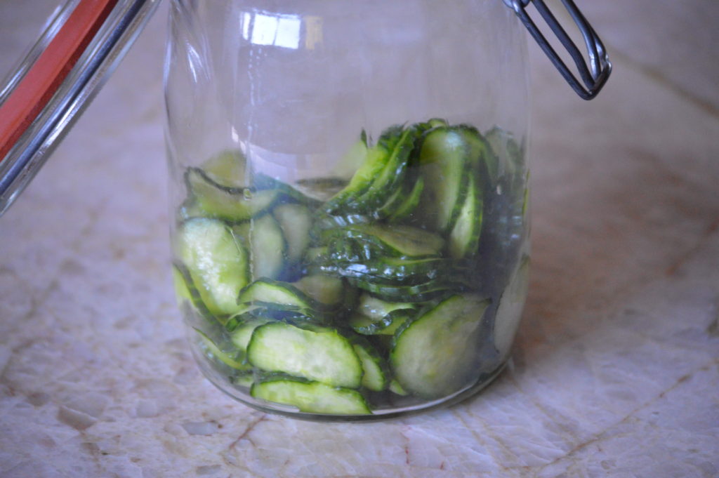the cucumbers are in a jar
