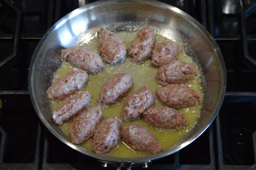 the meatballs cooking on one side