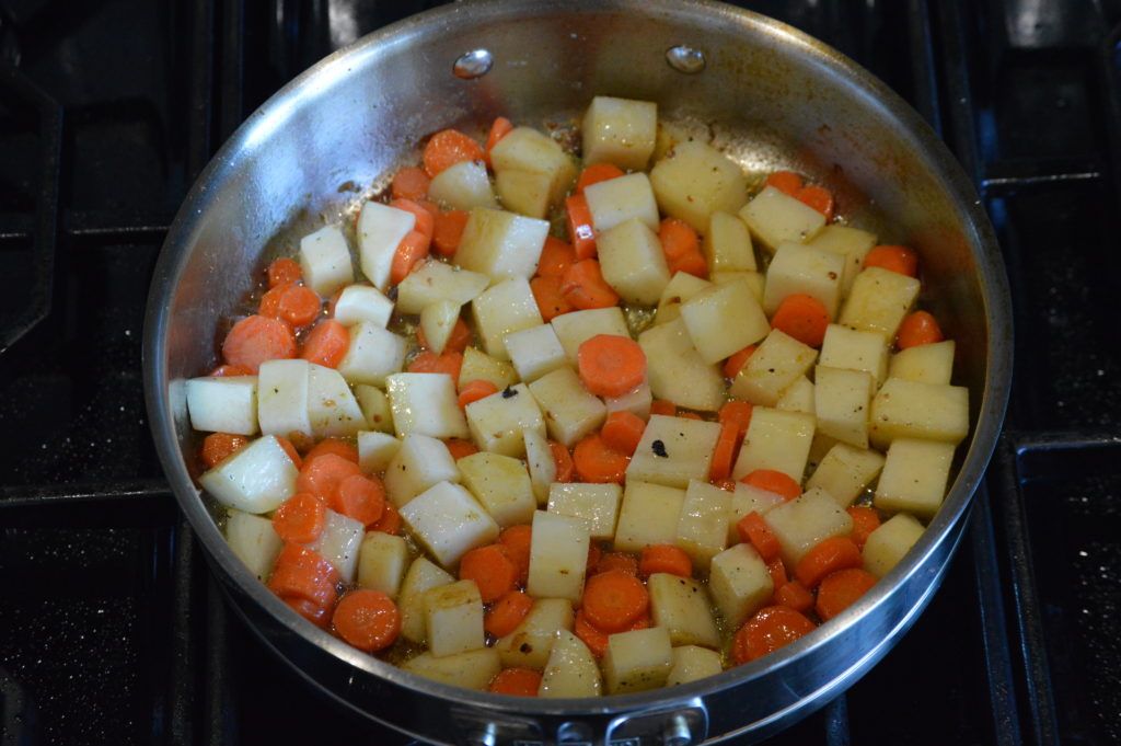 sautéing the potatoes and carrots