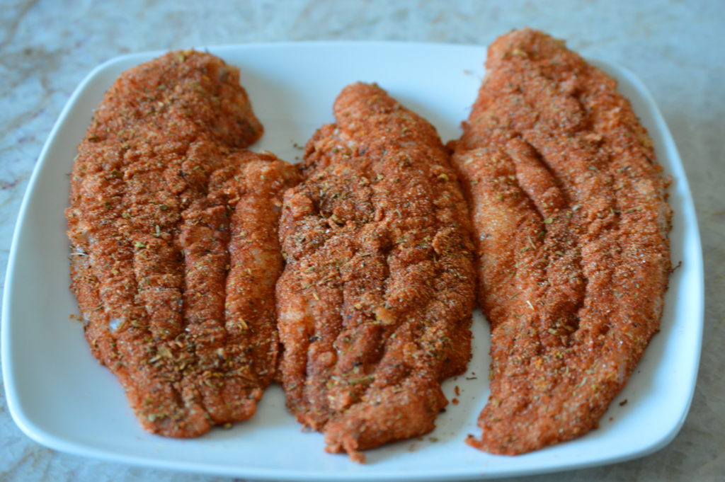 the catfish are coated in butter and cajun seasoning