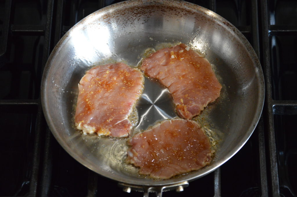the pork chops are added to the hot pan