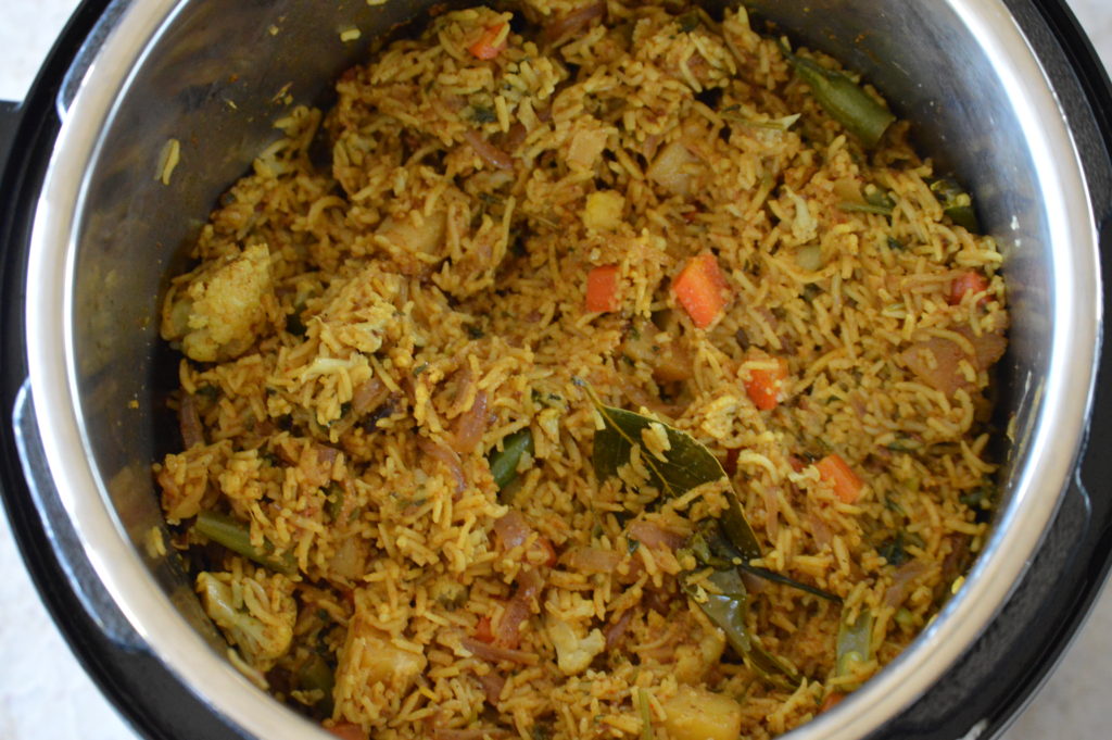 the vegetable biryani is finished cooking and fluffed
