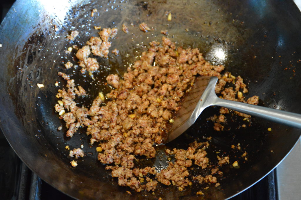 ground pork is added and cooked