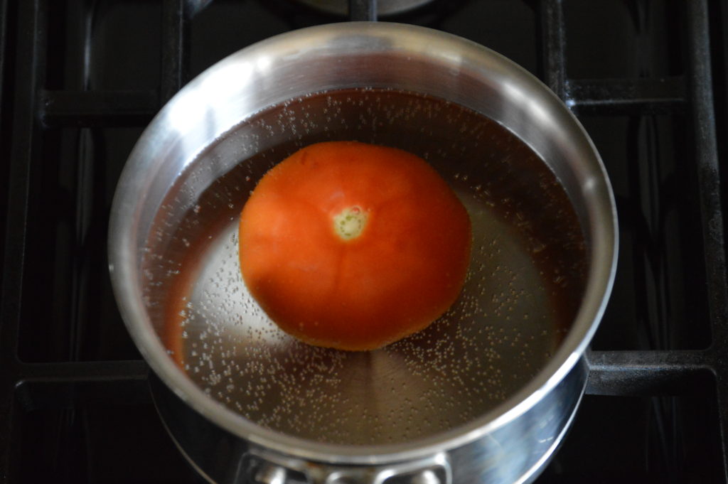 boiling the tomato in a small pot