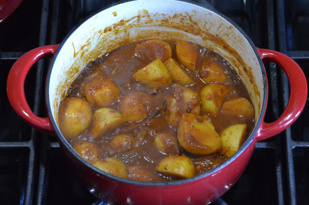 the potatoes (aloo) are cooked and the sauce has thickened