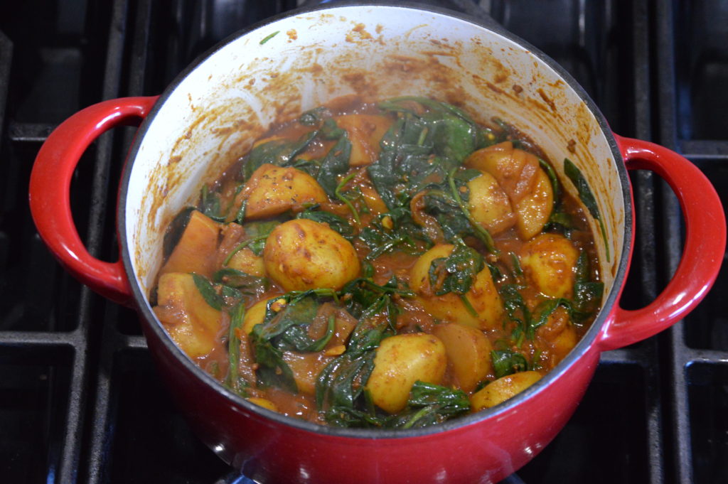 the spinach has wilted and the saag aloo is finished
