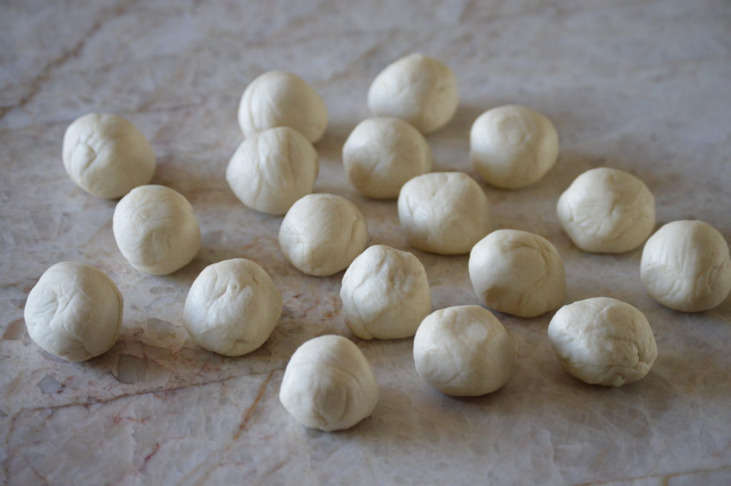 the dough is divided and rolled into balls
