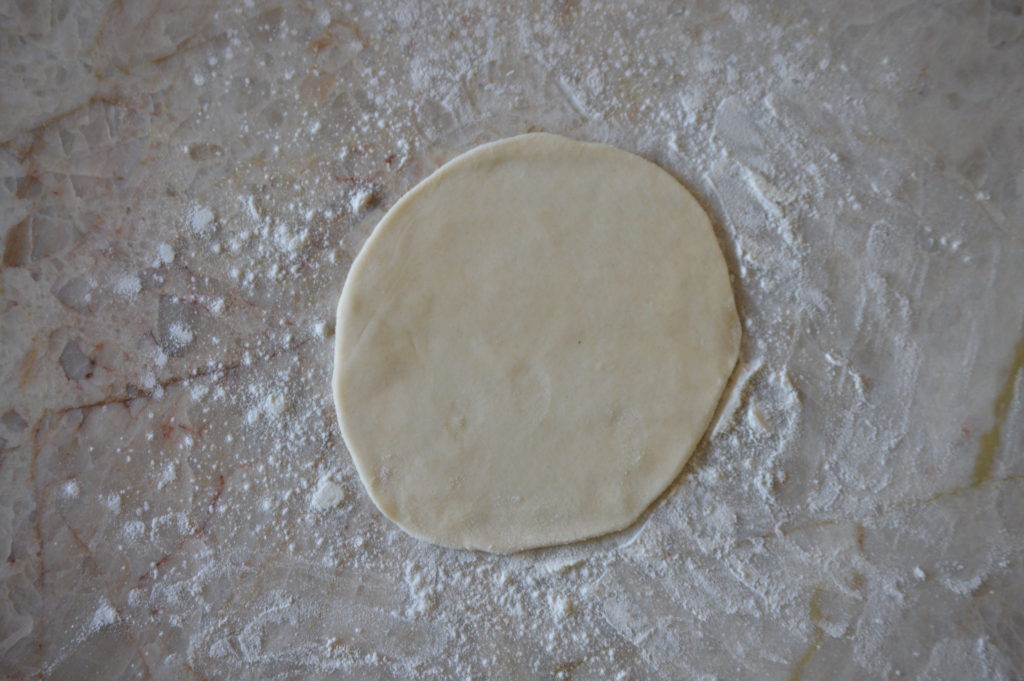 the dough is flipped and rolled out again