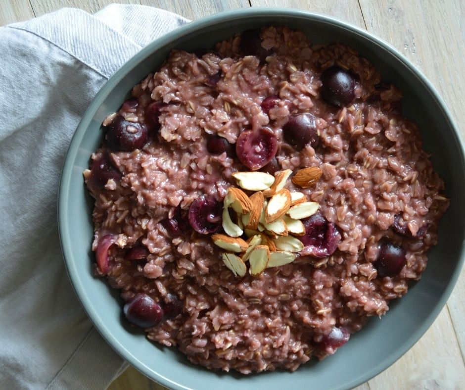a bowl of the finished almond cherry oatmeal