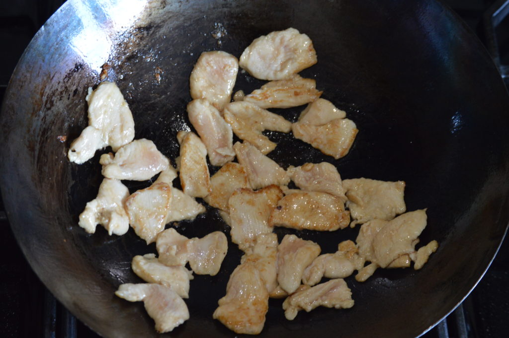 cooking the chicken in a wok