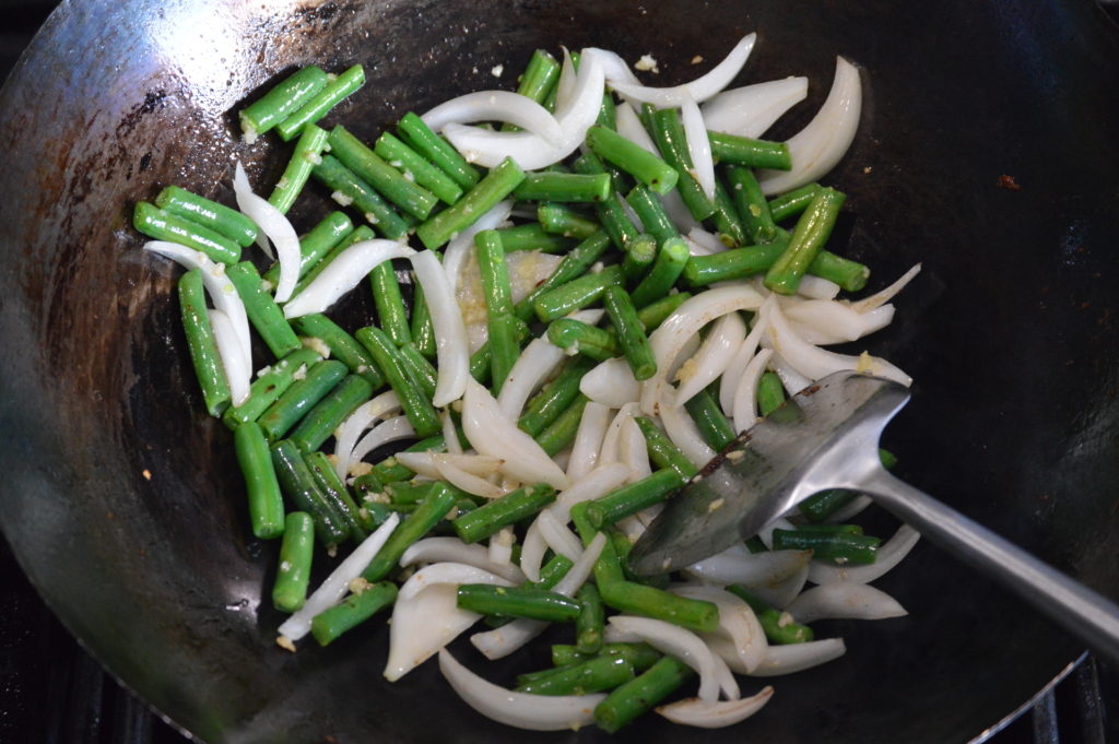 stir frying the green bean and onion