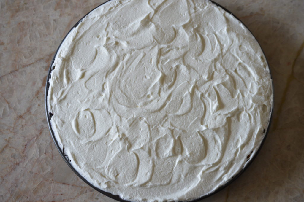 the whipped cream is spread over the tart