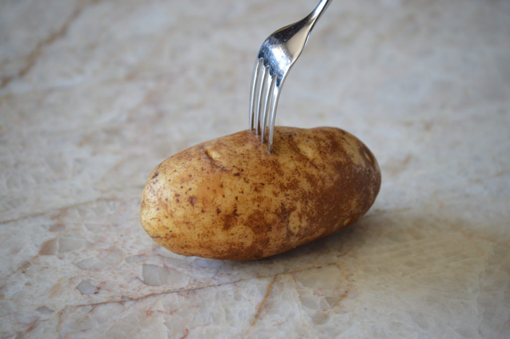 poking holes in the potatoes