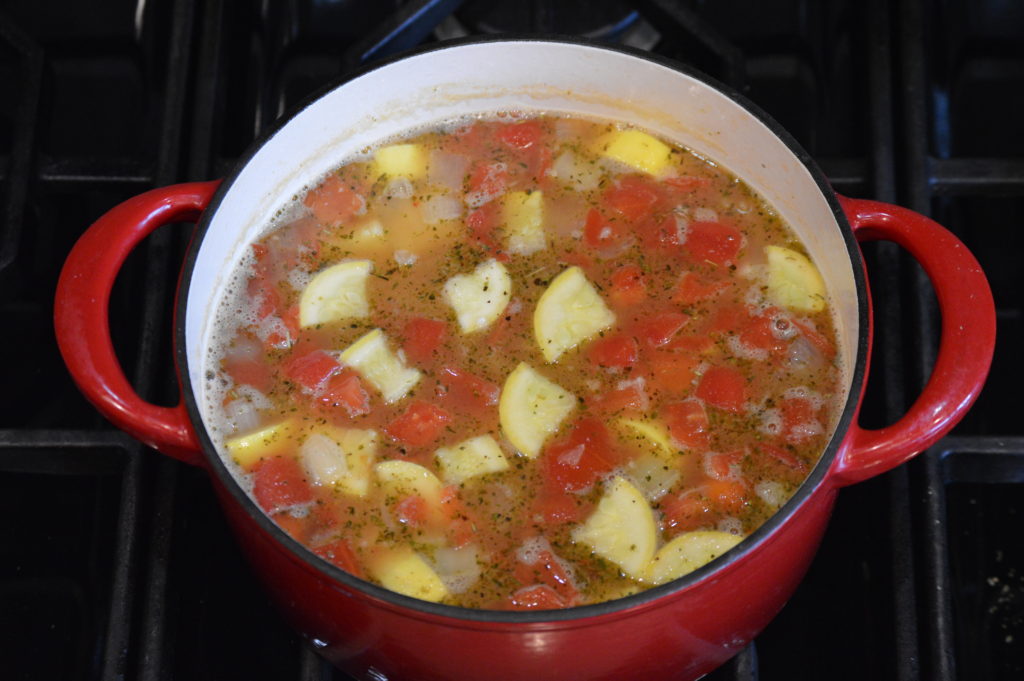 the tomato, beans, squash, and seasoning is added to the pot