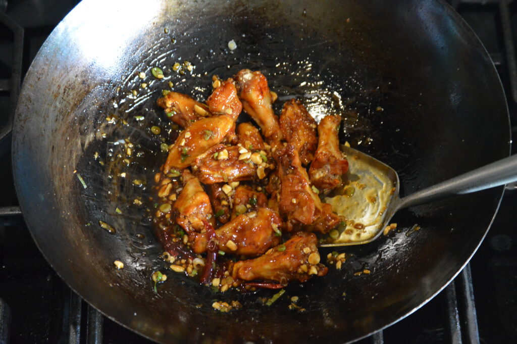 the baked wings are coated in the kung pao sauce.