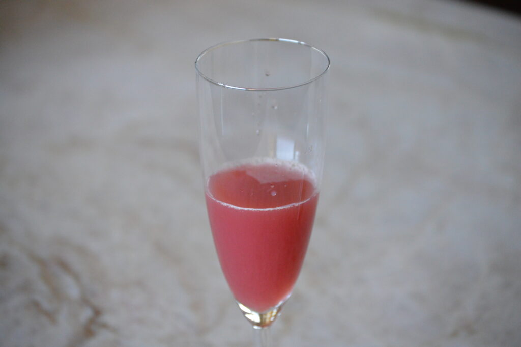 the cranberry juice and orange juice in a champagne flute