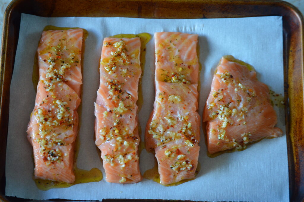 the basting sauce is poured over the salmon portions