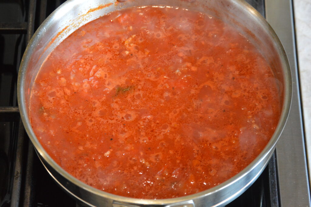the tomatoes are added and the sauce is let to simmer