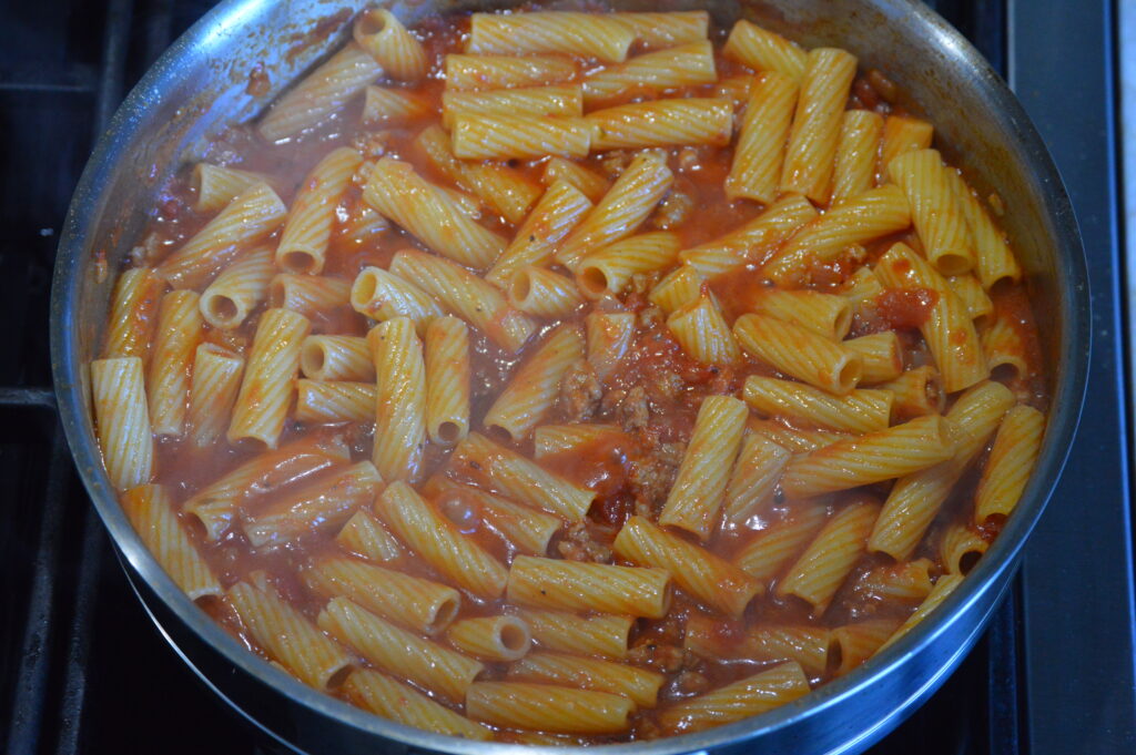 the rigatoni is added and cooked in the sausage sauce