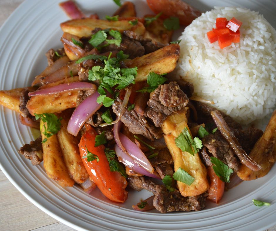 a plate of the finished lomo saltado with rice