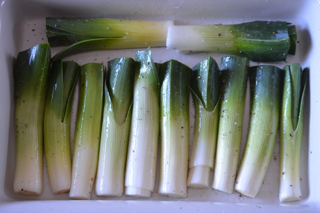 the leeks are coated in oil, salt, and black pepper