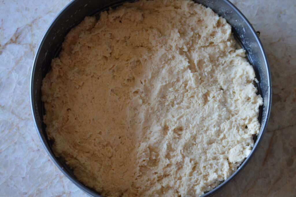 batter is pressed down into a springform pan