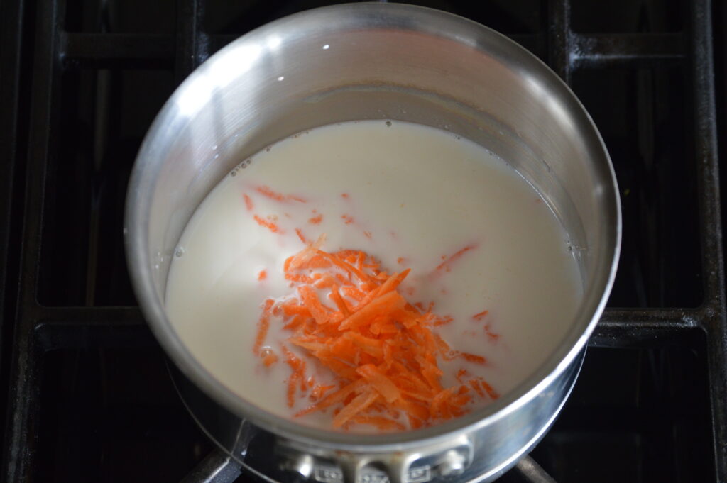 the carrots and milk are in a pot